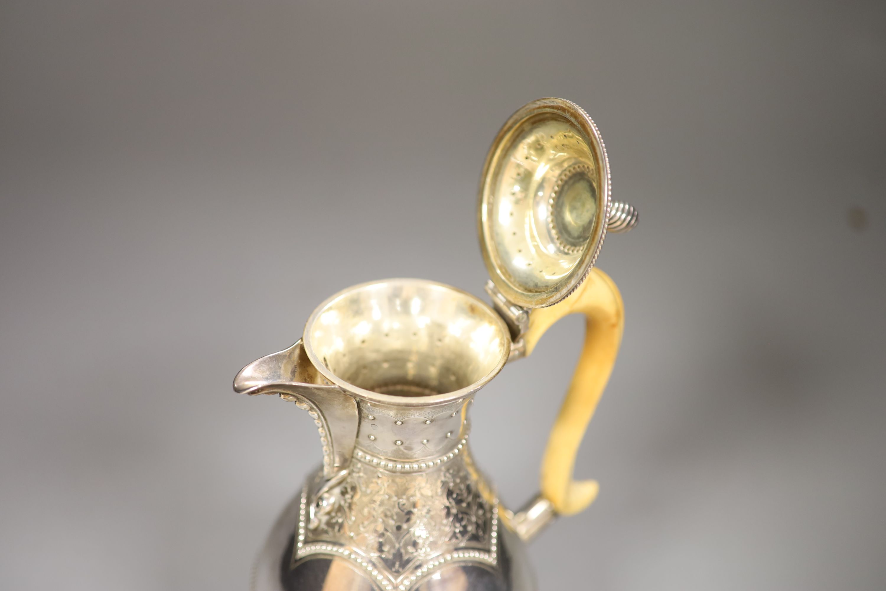 A Victorian silver baluster hot water pot, Henry Holland, London, 1878, with ivory handle, height 23.8cm, gross 15oz.